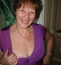 a girl with a thick black knob on her pecs is plumbing the man in his sofa